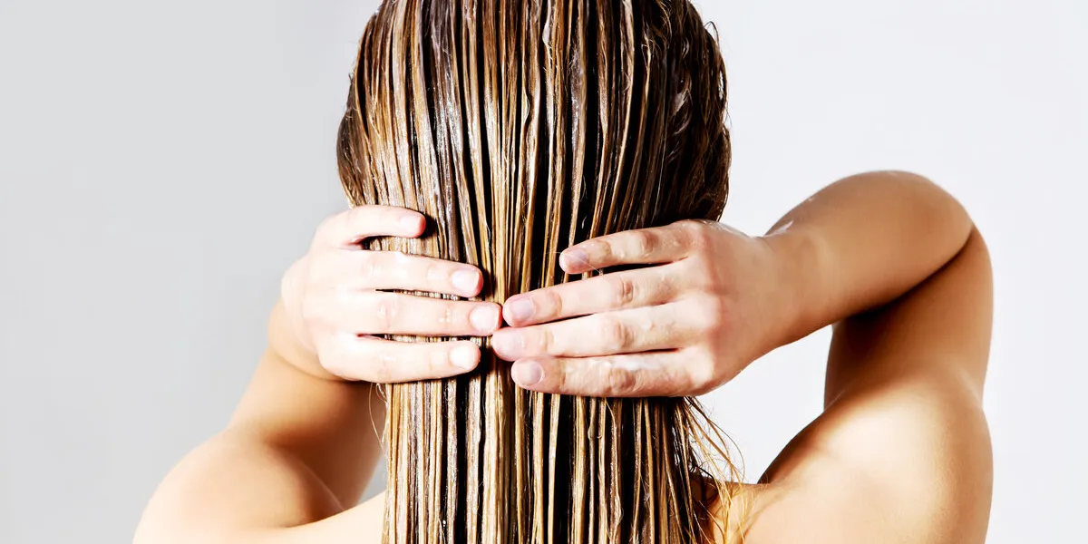 blond woman applying hair conditioner isolated on white blond woman applying hair conditioner isolated on white