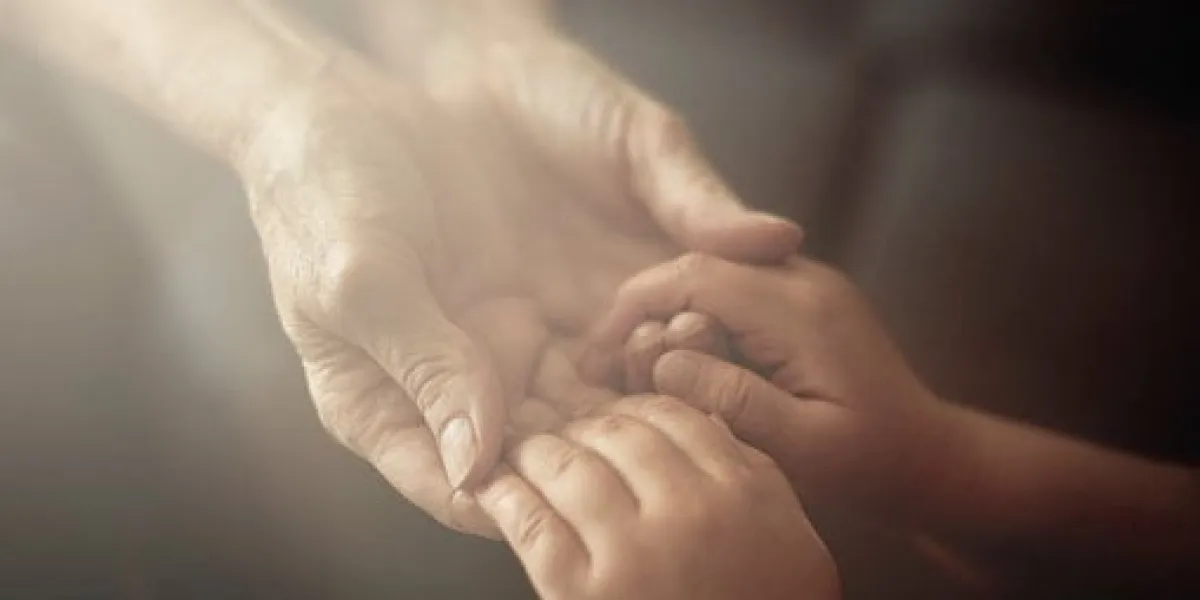 grandson holding grandmother hands close up view