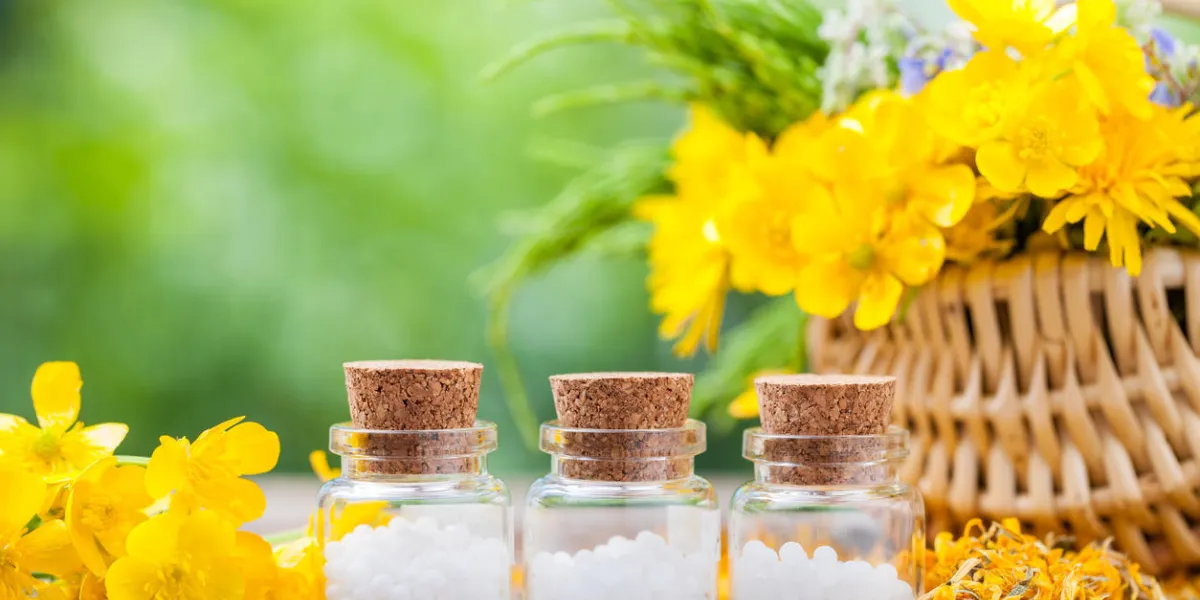 bouteilles de globules homéopathiques et herbes saines dans un panier en osier bouteilles de globules homéopathiques et herbes saines dans un panier en osier