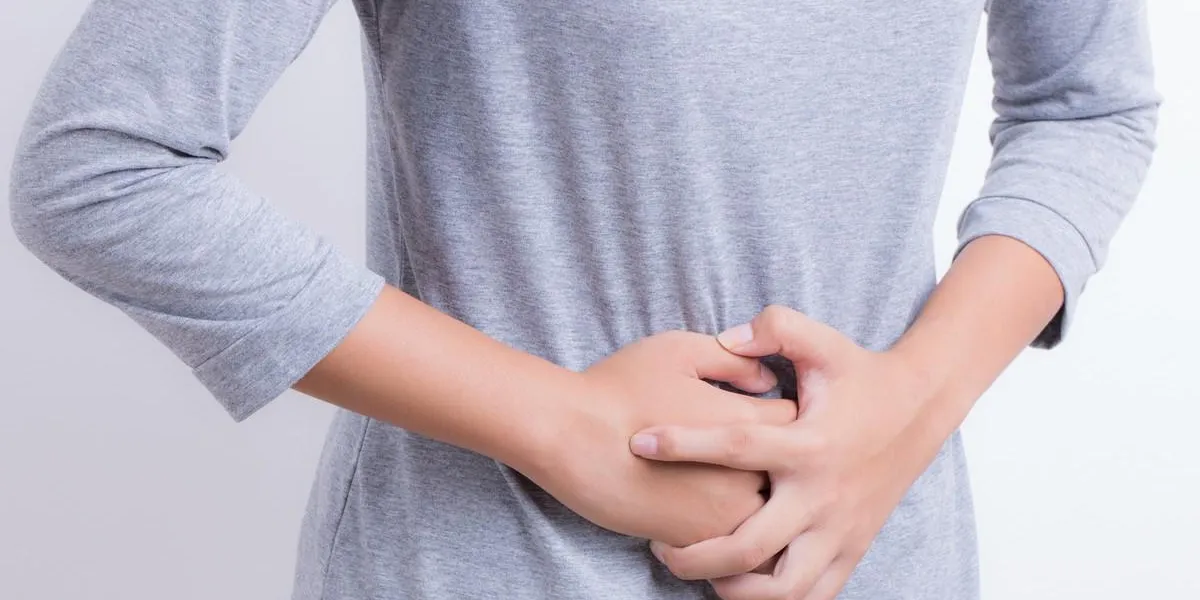 asian woman having stomachache
