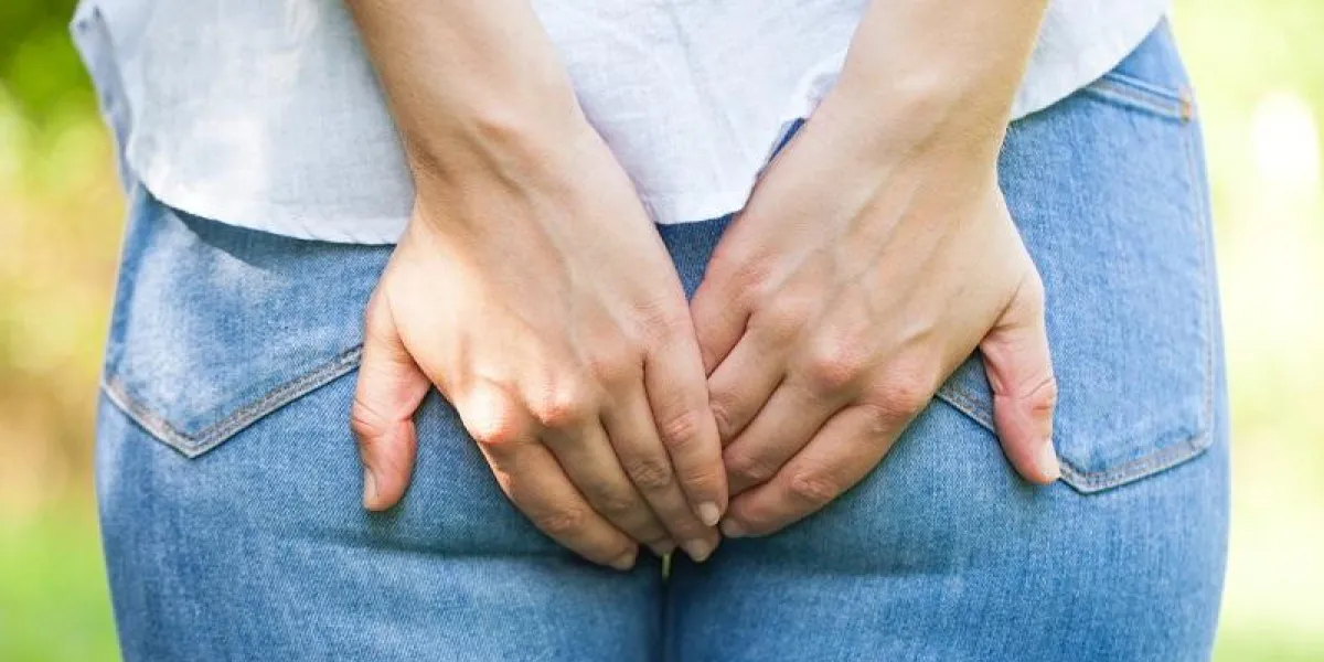 close up picture of a young woman holding her butt, she needs to poop, outdoor close up picture of a young woman holding her butt, she needs to poop, outdoor