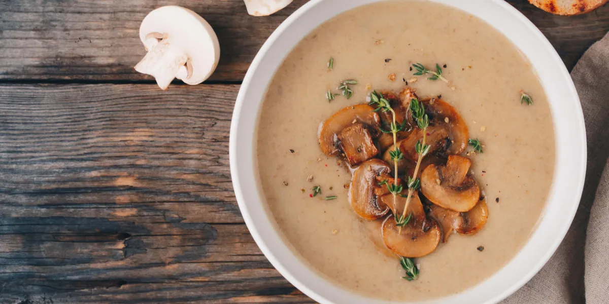cream soup puree with mushroom with toast bread on wooden background