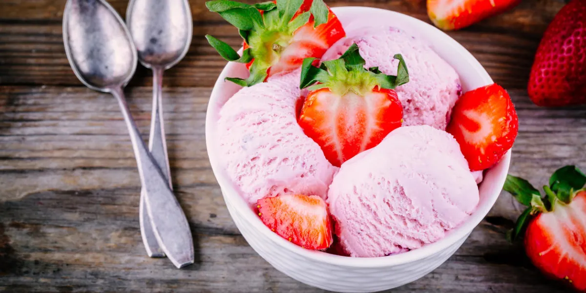homemade yoghurt ice cream with fresh strawberries on wooden background homemade yoghurt ice cream with fresh strawberries on wooden background