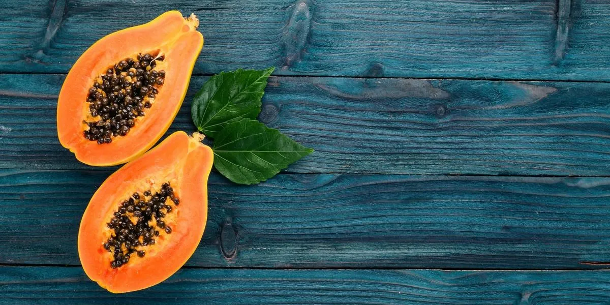 papaya tropical fruits on a wooden background top view copy space