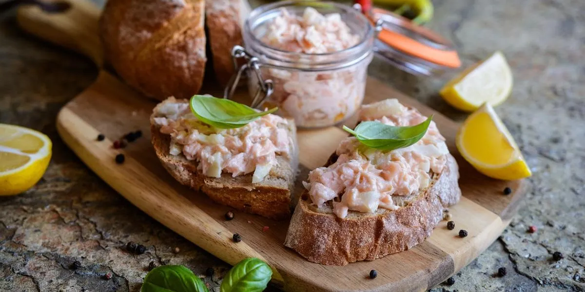 delicious salmon spread with cream cheese and onion on whole grain bread slices