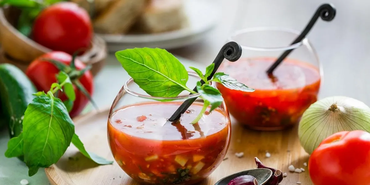 tomato gazpacho soup with fresh cucumbers, red pepper, green basil, onions tomato gazpacho soup with fresh cucumbers, red pepper, green basil, onions