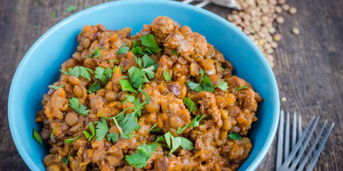 frash lentil stew with bolognese sauce in a bowl with parsley on rustic wooden table italian food concept heathy vegetarian food selective focus frash lentil stew with bolognese sauce in a bowl with parsley on rustic wooden table italian food concept heathy vegetarian food selective focus