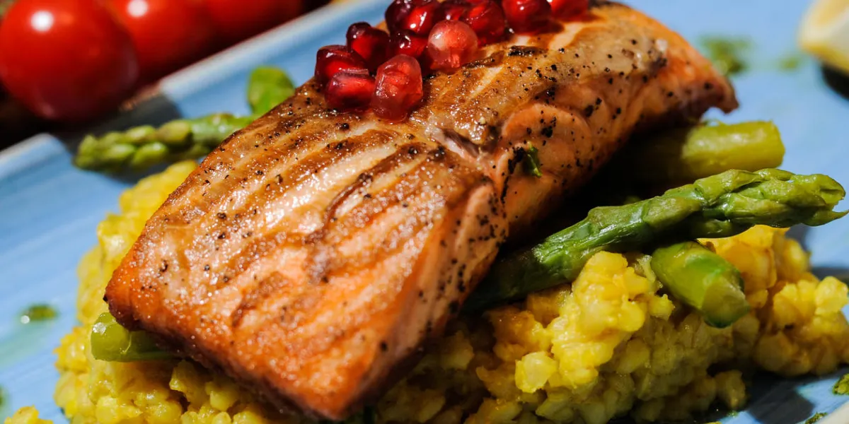 pan fried salmon fillet served with asparaagus barley, pomerganate and olive oil
