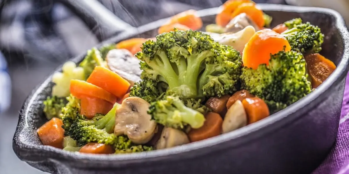 vegan pan vegetarian food - broccoli carrot mushrooms salt pepper on butter vegan pan vegetarian food - broccoli carrot mushrooms salt pepper on butter