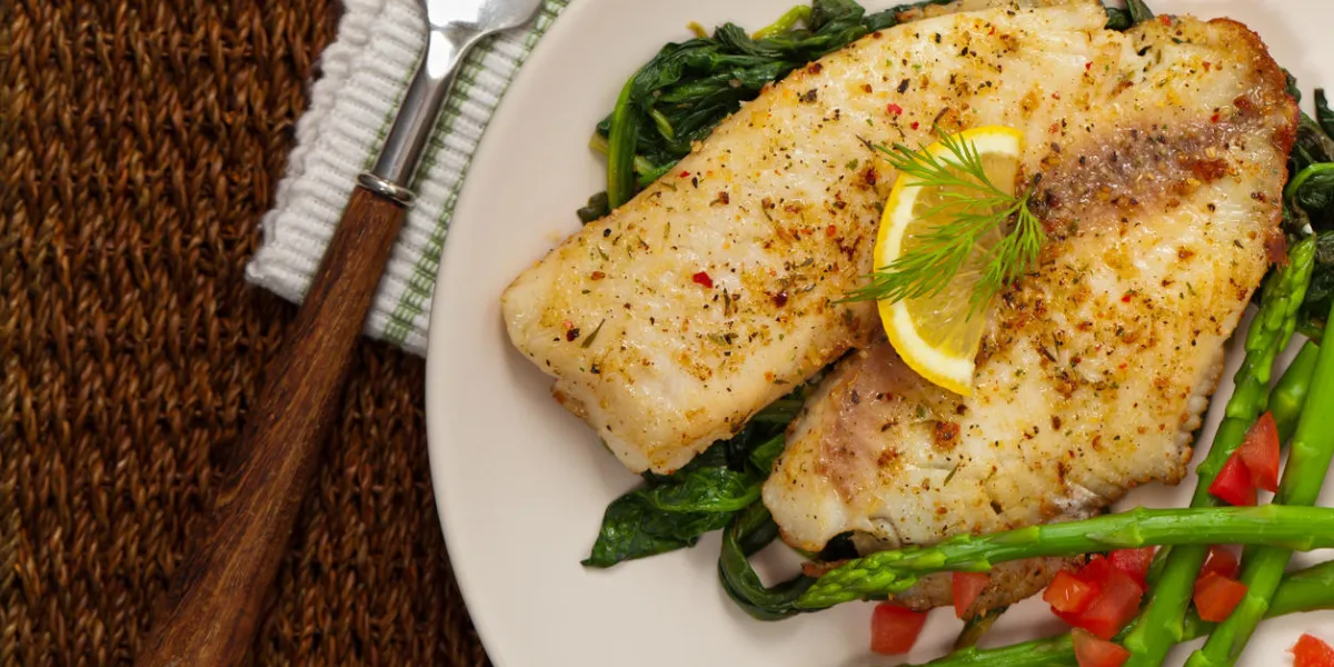 whitefish with roasted asparagus selective focus