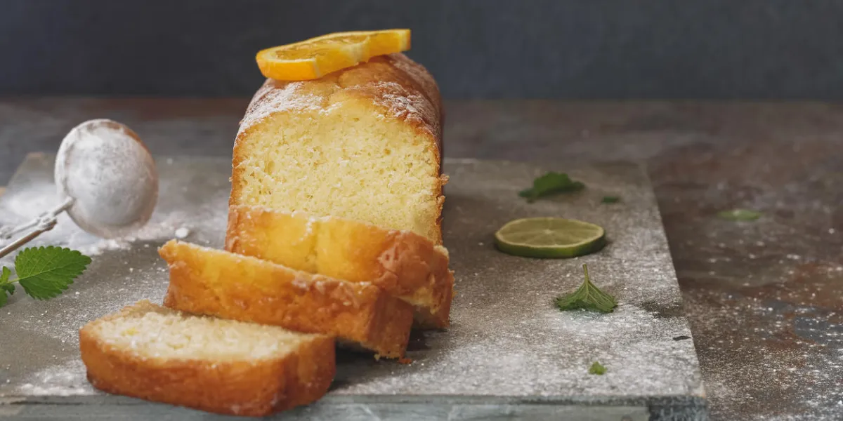 sicilian orange cake partly sliced and fresh fruits selective focus, vintage toned image, blank space sicilian orange cake partly sliced and fresh fruits selective focus, vintage toned image, blank space