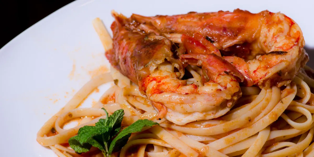 a delicious plate with shrimps, tagliatelle and sauce