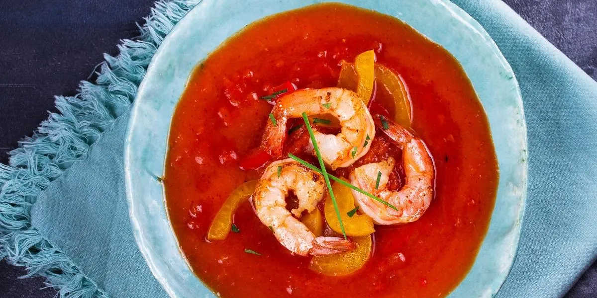 shrimp gazpacho with red and yellow bell pepper spanish soup vegetable puree with prawns view from above, top studio shot shrimp gazpacho with red and yellow bell pepper spanish soup vegetable puree with prawns view from above, top studio shot