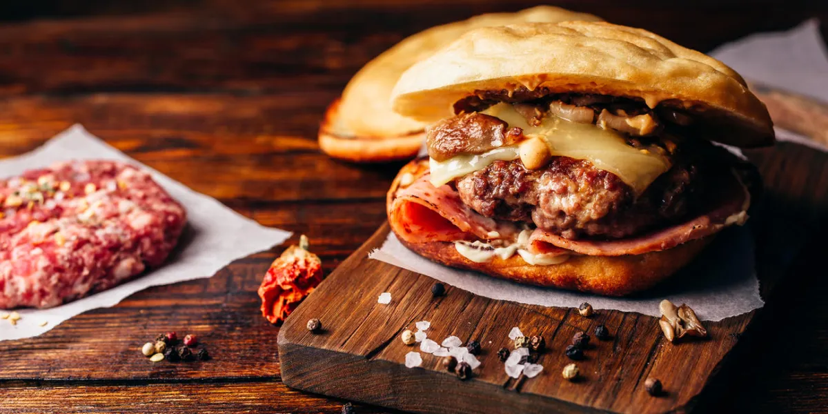 cheeseburger with beef patty, wisconsin swiss cheese, ham, sauteed mushrooms, dijon mustard, mayonnaise and potato roll cheeseburger with beef patty, wisconsin swiss cheese, ham, sauteed mushrooms, dijon mustard, mayonnaise and potato roll