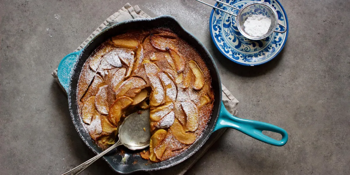 roasted apple clafoutis (french custard cake) in cast iron pan
