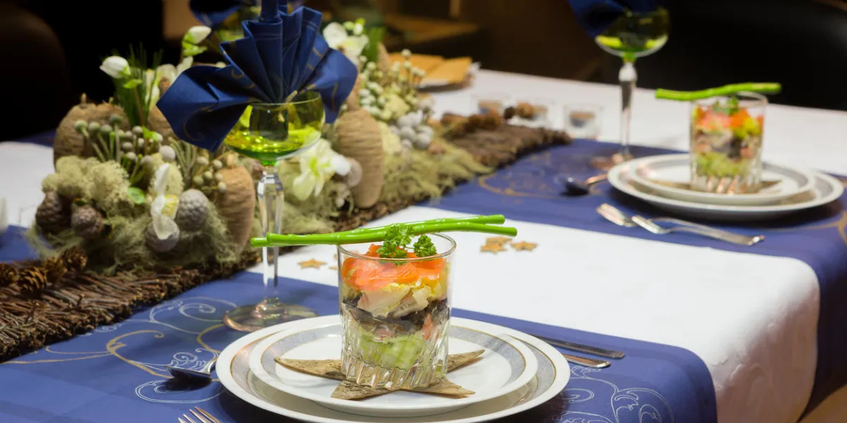 decorated christmas dinner table with seafood verrine als a starter